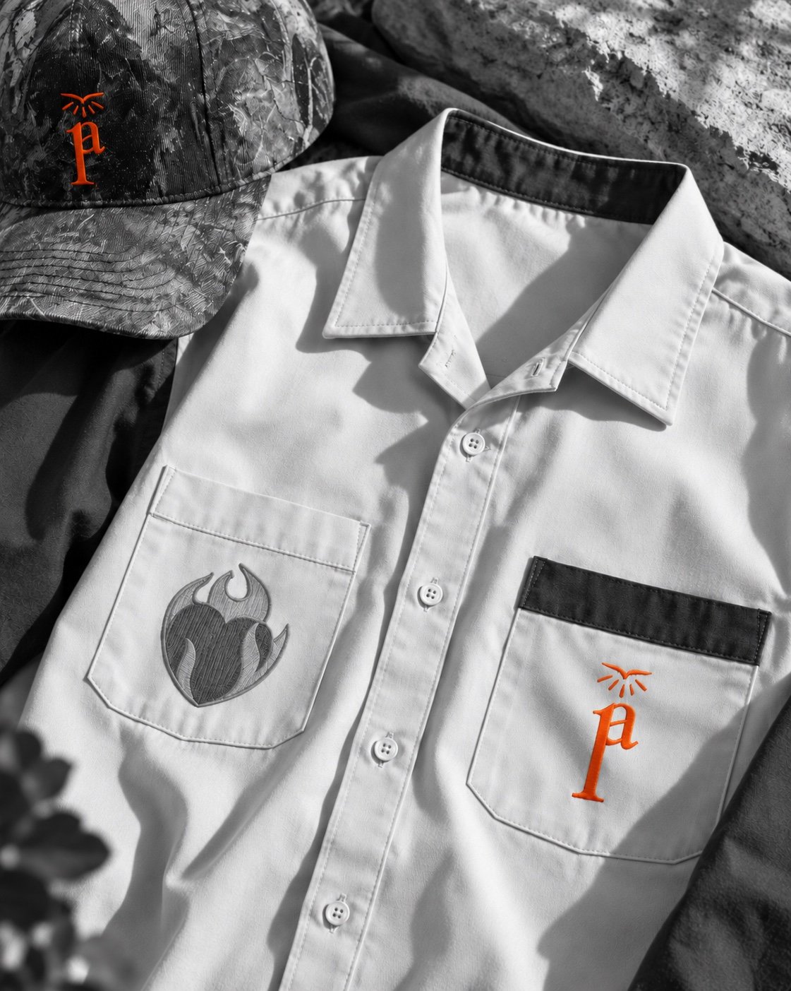 Close detail of the workwear shirt and camouflage cap